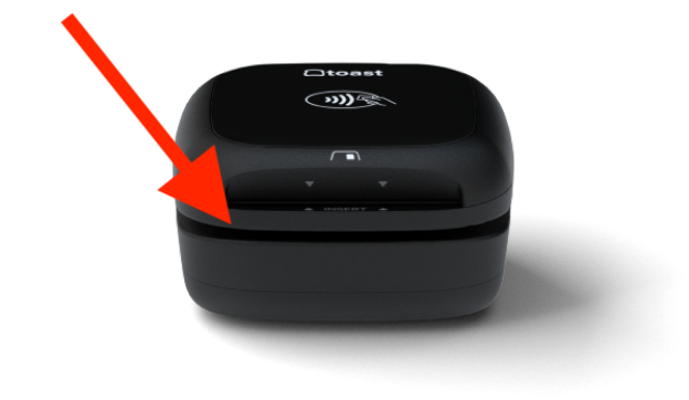 Toast Tap payment puck with a red arrow pointing to the magnetic-stripe swipe slot on the front of the device.